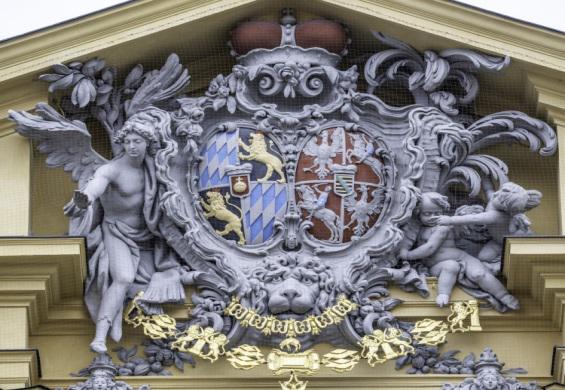Coat of arms of Vienna featuring a shield with a black eagle and a red background, symbolizing the city's heritage.